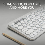 A slim white wireless keyboard with gray modifier keys