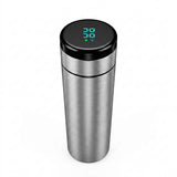 Brushed stainless steel travel tumbler with a digital temperature display showing 38° C