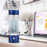 A portable electric blender bottle with a blue lid and base