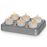 Battery-operated LED tea light candles in a rectangular charging base