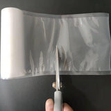 A roll of clear plastic mesh or vinyl film - Vacuum Sealer Roll