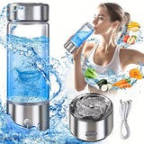A portable electric water blaster bottle with a clear body, silver metal top and base